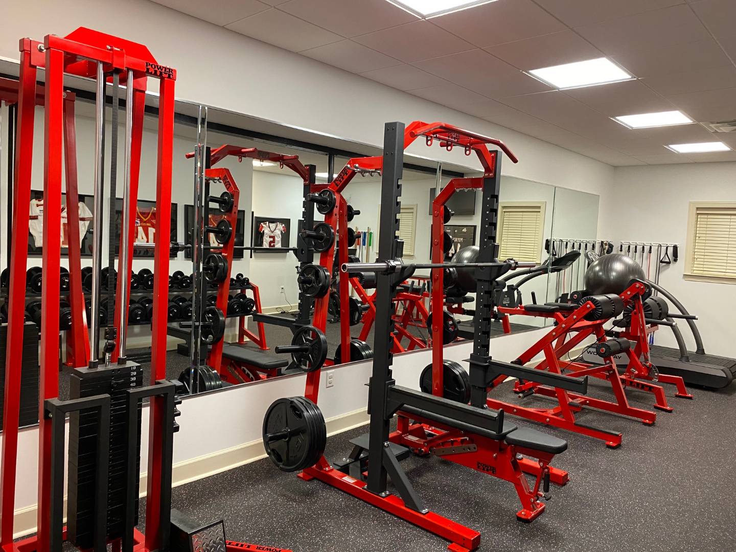 Luxury Custom Garage Gym Outfitted with Power Lift Power Racks and Benches